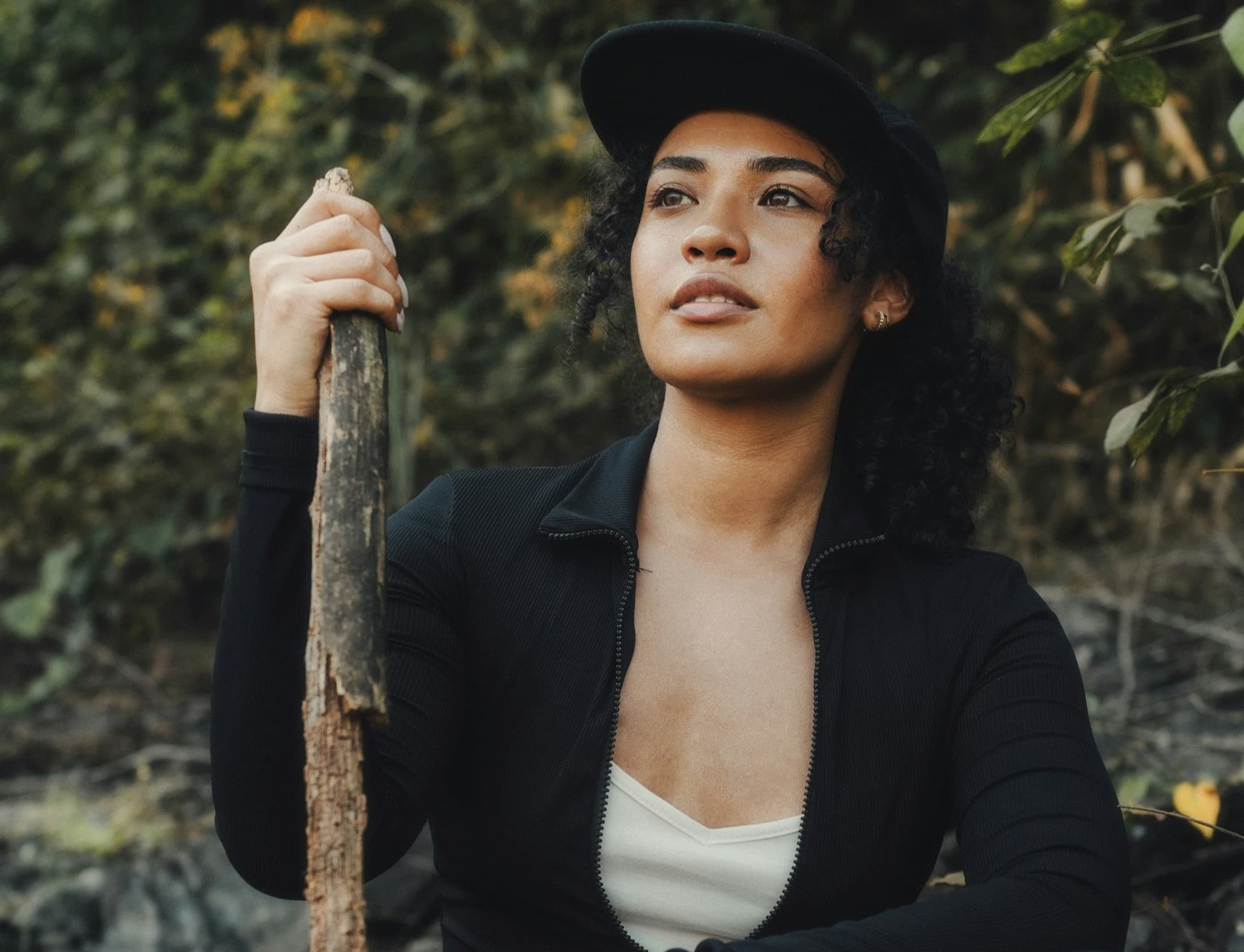 A photo of Samir Venegas, holding a walking stick on a hiking trail